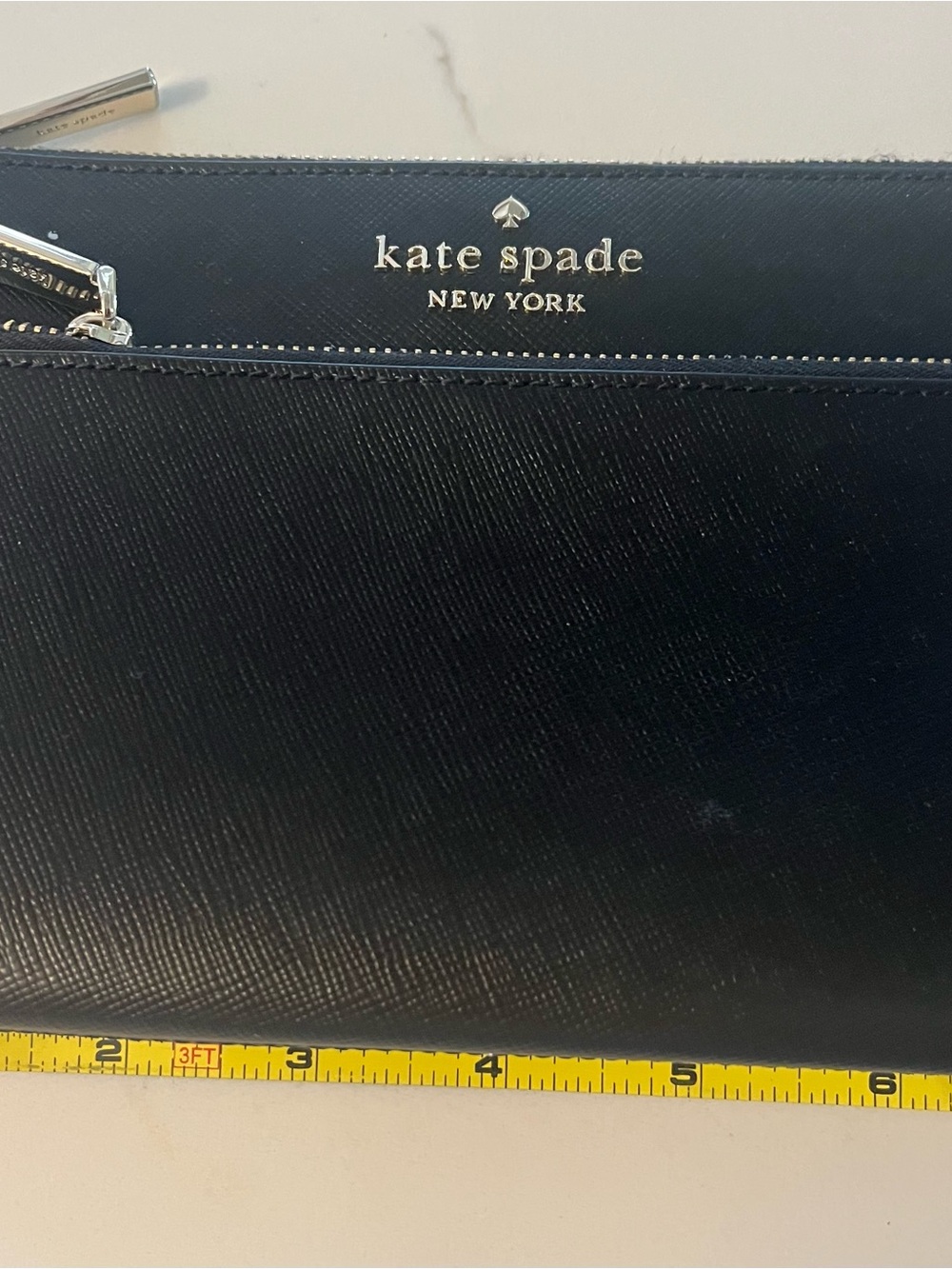 kate spade black leather wristlet with gold logo